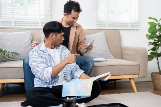 The couple is engaged in a lively discussion about their travel plans, showcasing their excitement while reviewing maps and travel details.