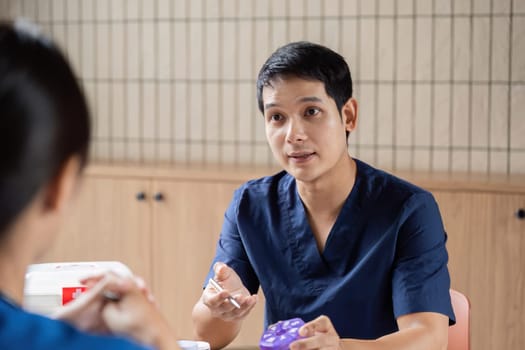 A healthcare provider articulates treatment options to colleagues, demonstrating effective communication and teamwork in a medical meeting setting.