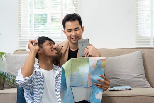 Two partners celebrate their travel plans, holding a map and passport while discussing their next adventure, showcasing love and excitement.