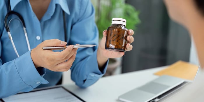 A doctor explains medication to a patient, focusing on health and wellness during a consultation.