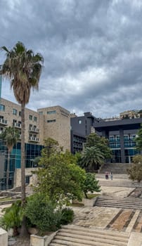 Budva, Montenegro - May 21, 2025: AVALA Hotel showcases modern architecture surrounded by palm trees and greenery