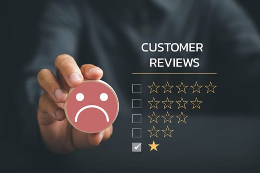 Conceptual representation of poor service. Unhappy customer holding wooden block with sad face icon on circle wooden table. Symbolizing bad customer experience and dissatisfaction.