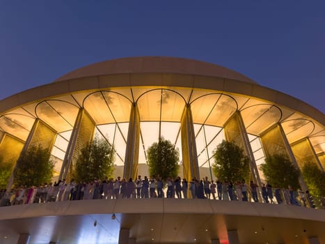 UAE, Dubai, 26 September 2024: people on the balcony of the central Apple store in Dubai Mall, The famous shopping center Dubai Mall and Burj Khalifa skyscraper at dusk. High quality photo
