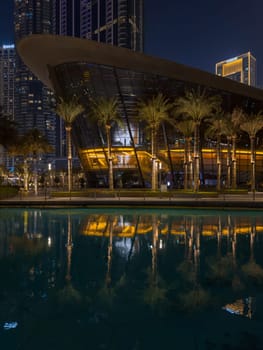 Dubai, UAE, 26 September 2024: Night view of the Dubai Opera near the Burj Khalifa Tower at night. High quality photo