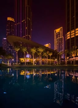 Dubai, UAE, 26 September 2024: Night view of the Dubai Opera near the Burj Khalifa Tower at night. High quality photo