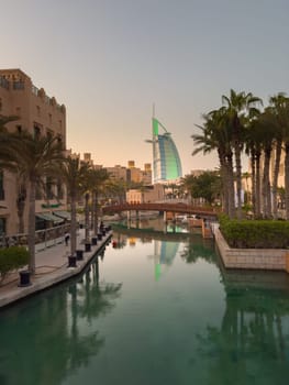 UAE, Dubai, 23 September 2024: night illumination of luxury hotel The Burj Al Arab Jumeirah Resort is located on its own island, with suites overlooking the sea, restaurants and a spa, embankment. High quality photo