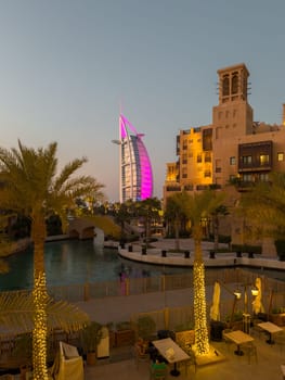 UAE, Dubai, 23 September 2024: night illumination of luxury hotel The Burj Al Arab Jumeirah Resort is located on its own island, with suites overlooking the sea, restaurants and a spa, embankment. High quality photo