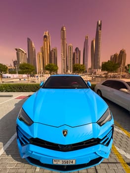 UAE, Dubai, 29 September 2024: Lamdorghini in Dubai harbor marina at sunny day, luxury yachts and boats are moored in port. High quality photo