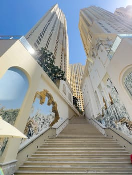 UAE, Dubai, 19 September 2024: architecture of the city at sunset, skyscrapers with glass facades. High quality photo