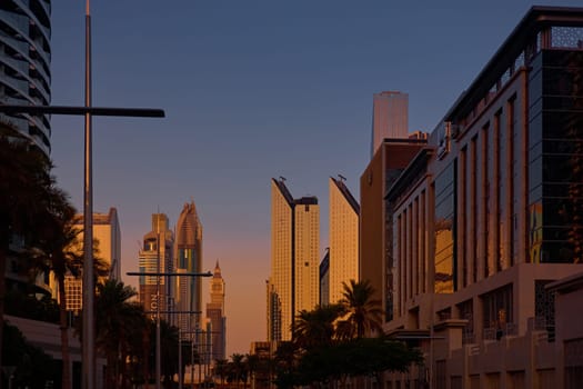 UAE, Dubai, 19 September 2024: architecture of the city at sunset, skyscrapers with glass facades. High quality photo
