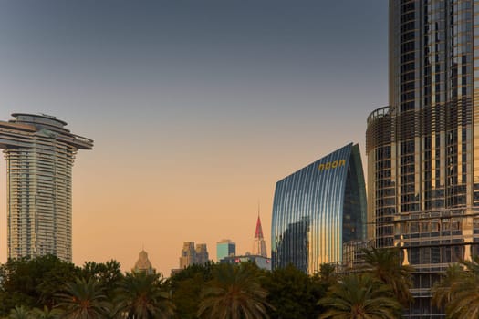 UAE, Dubai, 19 September 2024: architecture of the city at sunset, skyscrapers with glass facades. High quality photo
