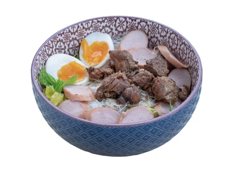 Dry rice vermicelli noodles (thin rice noodles) with cutting sausage, boiled egg and braised pork (stewed pork) and vegetables in ceramic bowl isolated on white background with clipping path.
