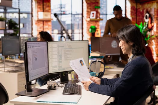 Tech startup company senior HR manager looking at CVs, doing talent acquisition for job. Experienced venture business recruiter reading resumes of candidates for IT engineering vacant position