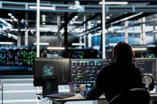 Server farm IT professional looks at data analysis graph to reduce infrastructure failure. Data center computer scientist looks at AI visualization dashboard to pinpoint equipment performance glitches
