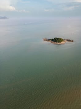 Picturesque aerial view of the Thailand coastline with golden sand and palm trees, glowing in bright sunlight on the Thai paradise landscape. Tropical travel destination at the seaside.