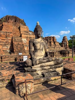 Ancient diversity of Buddha statues sit peacefully in a historic temple, Wat Maha That landmark representing faith and spirituality. Beautiful culture religious destination in Thailand.