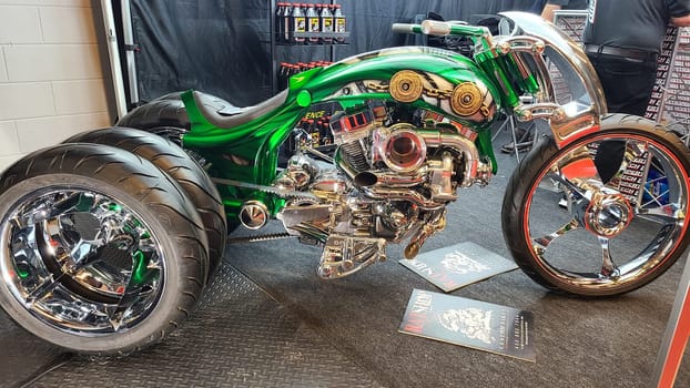 Montreal, QC Canada - 02.25.2023: Custom Trike Motorcycle with Chrome and Green Paint Job on Display, Mesmerizing Design.
