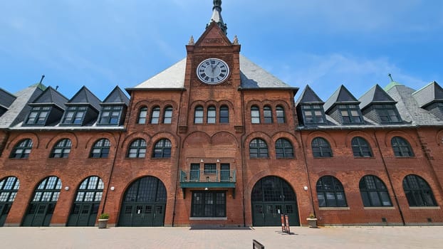 New York, NY USA - 07.07.2023: Historical Train Station Architecture with Clock Tower and Arched Windows, Sunny Day.