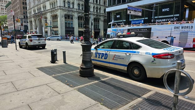 New York, NY USA - 07.08.2023: Urban Policing NYPD Vehicle on City Street Amidst Architectural Grandeur and Public Life.