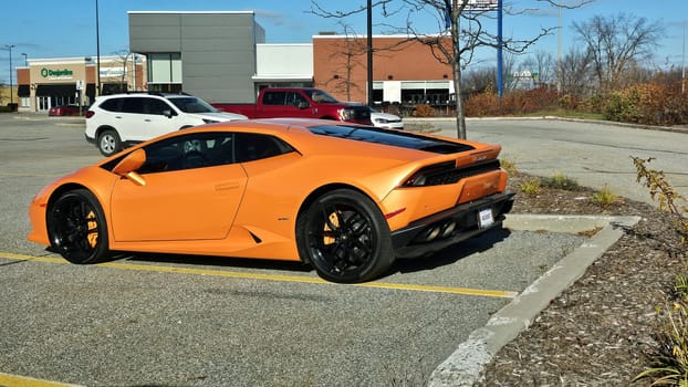Ottawa, ON Canada - 11.12.2023: Vibrant orange Sports Car Parked in a Lot on Sunny Day - Automotive and Transportation Theme.