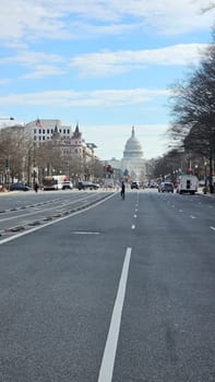 Washington D.C. USA - 12.29.2023: View of the United States Capitol Building with a Wide Asphalt Road Leading to It.