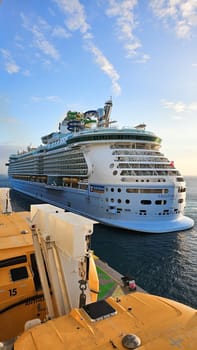 Cape Canaveral, FL USA - 02.12.2024: Giant Cruise Ship Sailing on the Ocean with Clear Blue Skies and Cloudy Weather, Sunny Day.