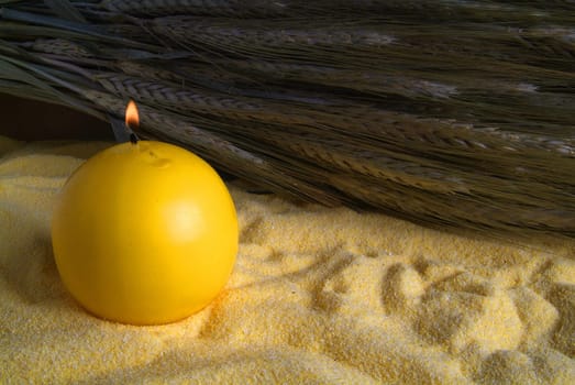 lighted candle and flour with bunch of oats