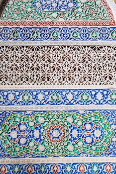 background of painted carved wooden celling with traditional Uzbek ornaments and colorful oriental patterns in Tashkent in Uzbekistan