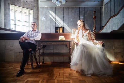 Bride and groom share a peaceful moment at their wedding registration, surrounded by elegant architecture and soft lighting that enhances their joy.