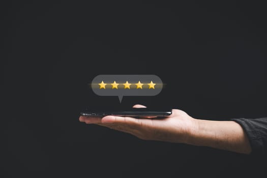Customer giving positive feedback with 5 stars rating on smartphone for best service experience. Business satisfaction survey and review concept for success, give five star for good service