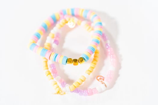 Little girl's charming bracelets adorned with clay and sea beads.