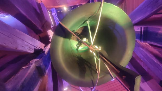 October 22 2024 Hradec Kralove, Czech Republic Europe, Kralov region, Kralovehradecky kraj, Large hanging bell. High quality photo violet vibrant wooden objects history museum church city music metal