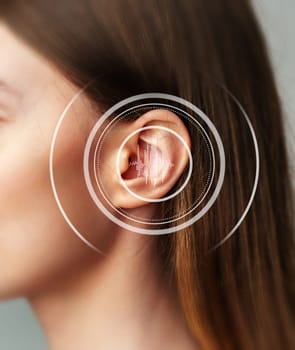 A close-up of a person's ear highlights the integration of sound technology aimed at improving auditory experiences in social interactions and various environments.