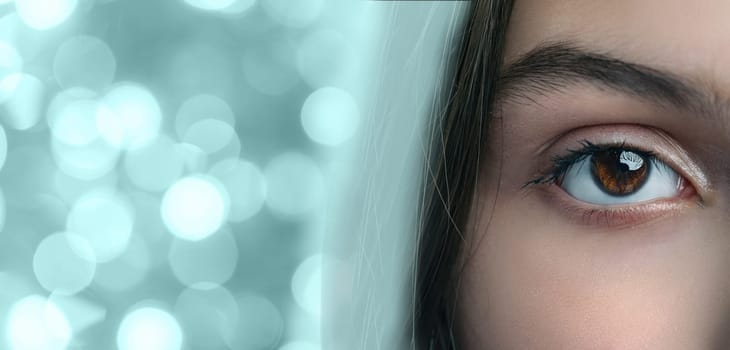 A close-up of a striking eye reveals deep brown hues and a reflective surface. The background features soft, out-of-focus lights that enhance the overall beauty of the gaze.