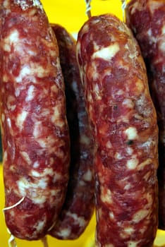 assortment of stacked raw salami in market