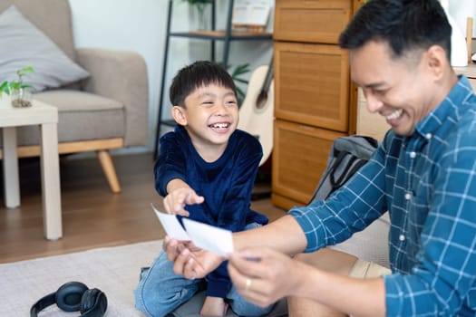 A father and son engage in playful activities at home, creating a positive atmosphere for back-to-school preparations. Their laughter and connection highlight the importance of family support in education.
