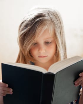 Close-Up Portrait Of A Sweet Girl Reading A Book