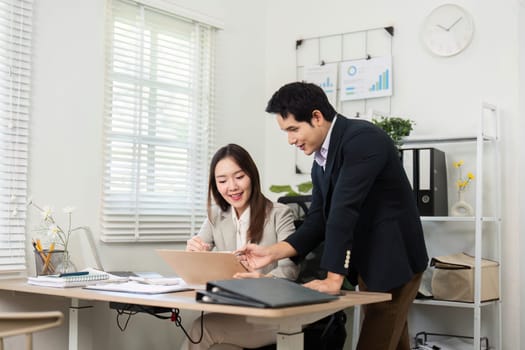A financial consultant and client review documents and discuss strategies, highlighting the importance of financial planning and collaboration.