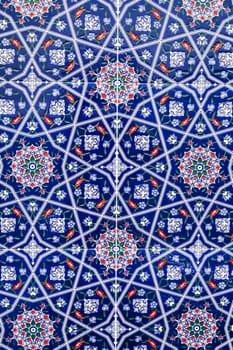 ceramic tiles with a traditional Uzbek oriental pattern in Uzbekistan. Blue decorative floral background with Islamic ornament