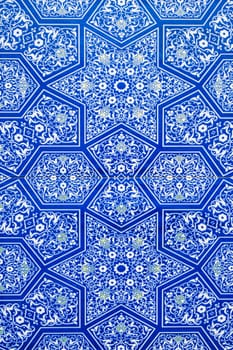 ceramic tiles with traditional Uzbek oriental pattern arabesque in Uzbekistan. Blue decorative geometric background with Islamic ornament