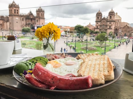 Delicious breakfast served with a stunning view of the plaza de armas in cusco, peru
