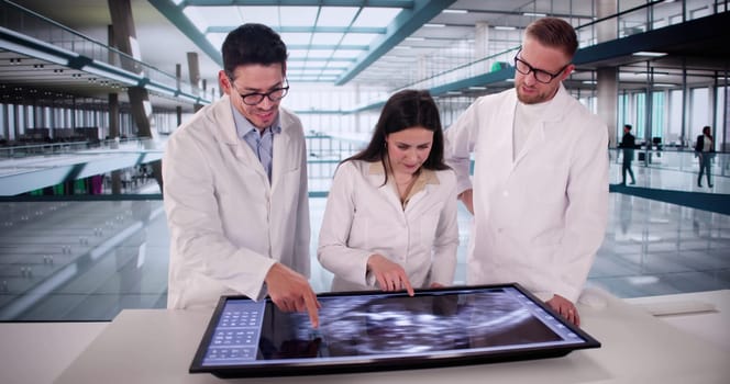 Medical Professionals Carefully Analyzing Ultrasound Scan Of Expecting Mother In Hospital.