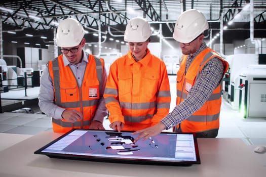Automotive Engineers Collaborate On Electric Vehicle Design At Manufacturing Plant.