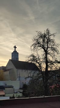 October 22 2024 Hradec Kralove, Czech Republic Europe, Kralov region, Church tree sunse religion sign objects building architecture house history museum . High quality photo editorial