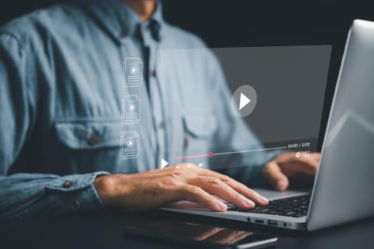 Man streaming videos on the internet with his laptop. Conceptual image of online streaming with a focus on the screen. Dive into a world of virtual performances, shows, and tutorials.
