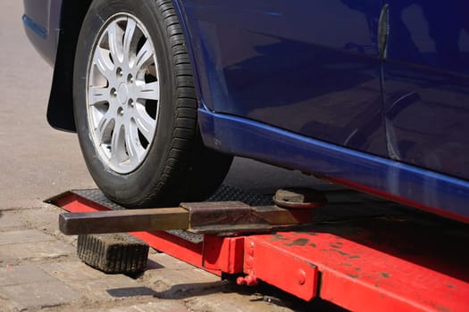Replacing a car wheel at a tire station. a rubber covering, typically inflated or surrounding an inflated inner tube