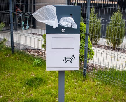 Close up shot of the box with single use plastic bags used for cleaning off pets excrement in the park