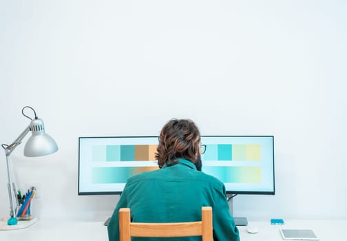 Unrecognizable graphic designer working with computer at modern office with copy space. High quality photo
