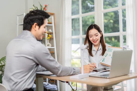 A professional woman presents ESG data to a client, focusing on sustainable practices and corporate governance.