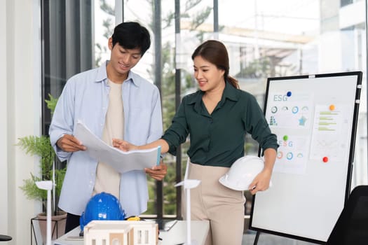 Engineers engage in a conversation about sustainable initiatives, showcasing teamwork and innovative project planning.